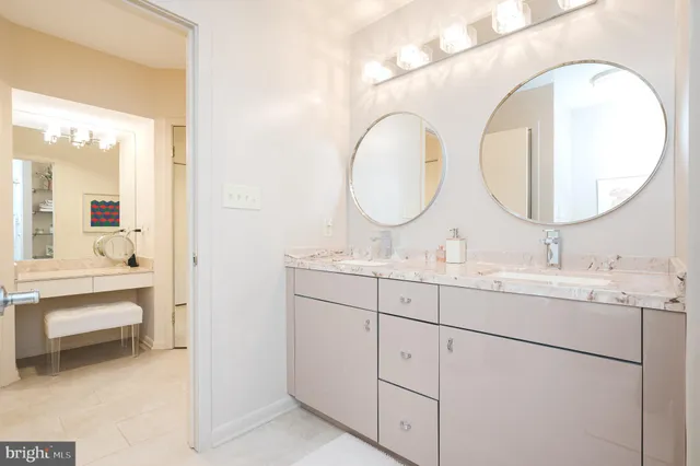 a bathroom with a double vanity sink and a mirror