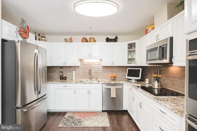 a kitchen with a sink a refrigerator and cabinets