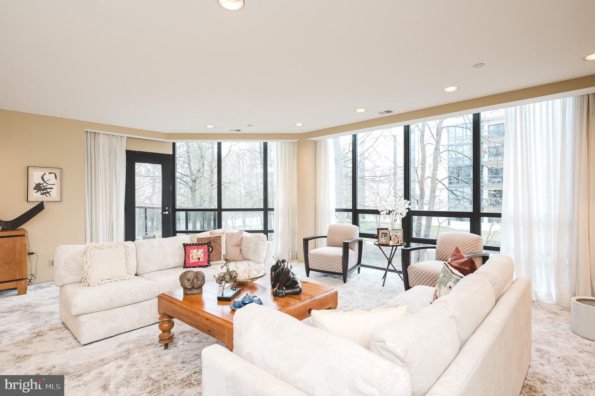 4001 Old Court Road, Unit 218 Baltimore, MD 21208 - Photo 10 of 44 a living room with furniture and large windows
