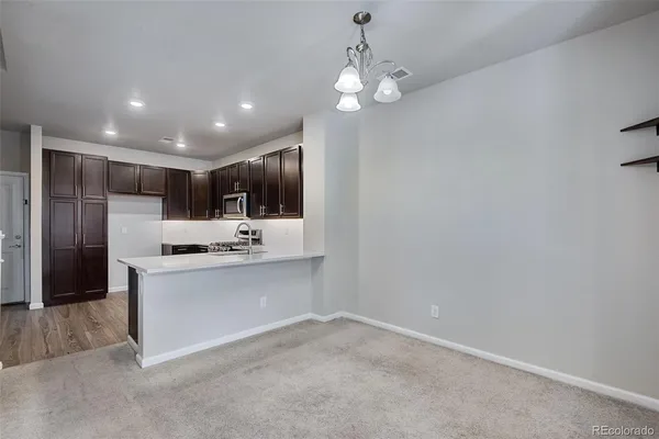 a open kitchen with a sink and stainless steel appliances