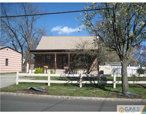 96 Magnolia Road Iselin, NJ 08830 - Photo 1 of 18 a front view of a house with a yard table and chairs