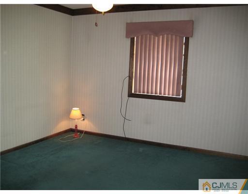96 Magnolia Road Iselin, NJ 08830 - Photo 3 of 18 a view of wooden floor in a room