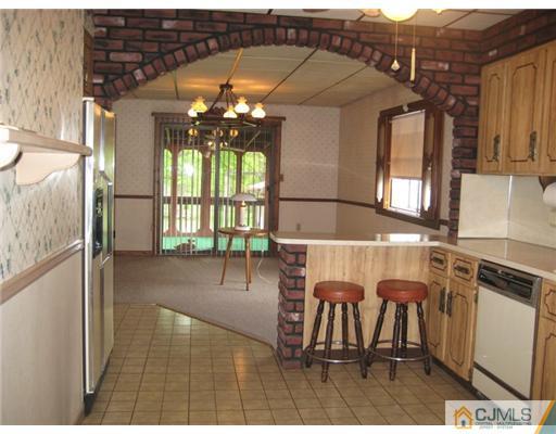 96 Magnolia Road Iselin, NJ 08830 - Photo 4 of 18 a view of a patio with a table and chairs