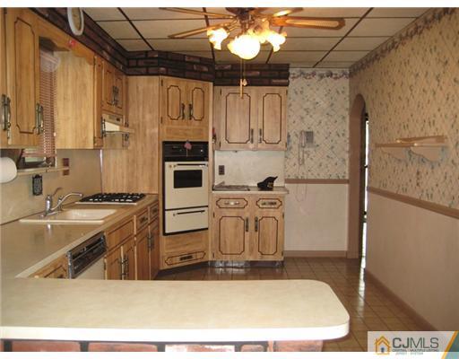 96 Magnolia Road Iselin, NJ 08830 - Photo 5 of 18 a kitchen with stainless steel appliances granite countertop a sink stove and refrigerator