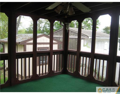 96 Magnolia Road Iselin, NJ 08830 - Photo 8 of 18 a view of a porch with a floor to ceiling window