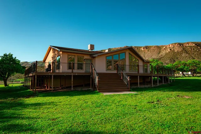 a view of a house with a yard and a garden