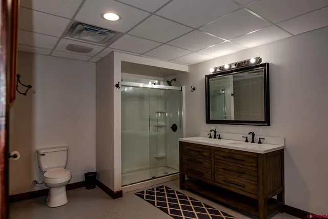 a bathroom with a sink toilet and shower