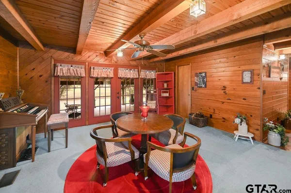 a dining room with furniture and wooden floor