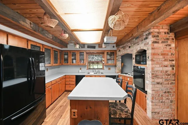 a view of kitchen island with furniture and wooden floor