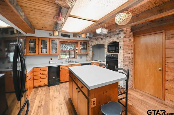 a kitchen with granite countertop a sink and a stove