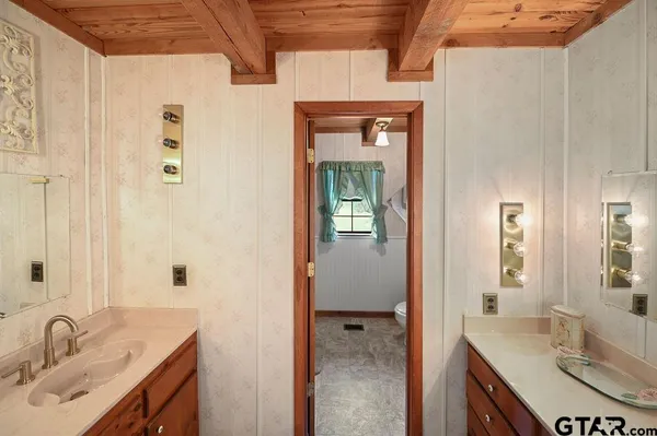 a bathroom with a toilet sink and mirror