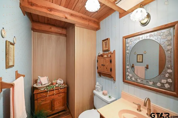 a bedroom with a bed mirror and window