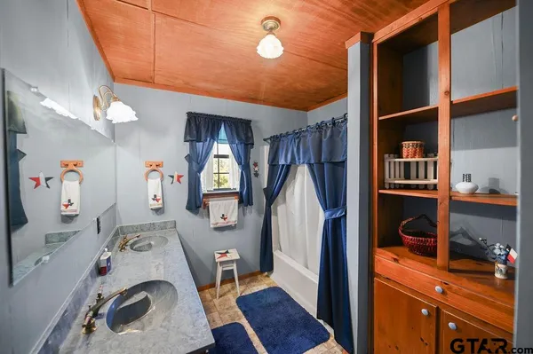 a bedroom with a bed mirror and a window