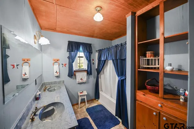 a bedroom with a bed mirror and a window