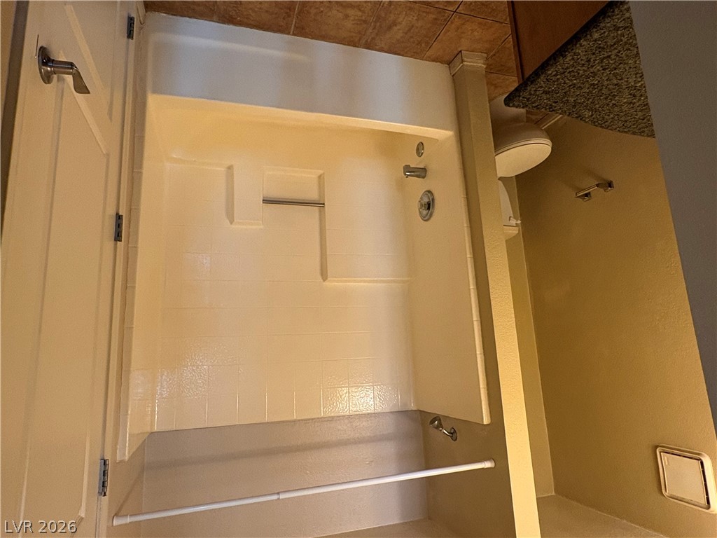 9325 West Desert Inn Road, Unit 123 Las Vegas, NV 89117 - Photo 11 of 36 A compact bathroom featuring a tiled shower, practical fixtures, and tile flooring.
