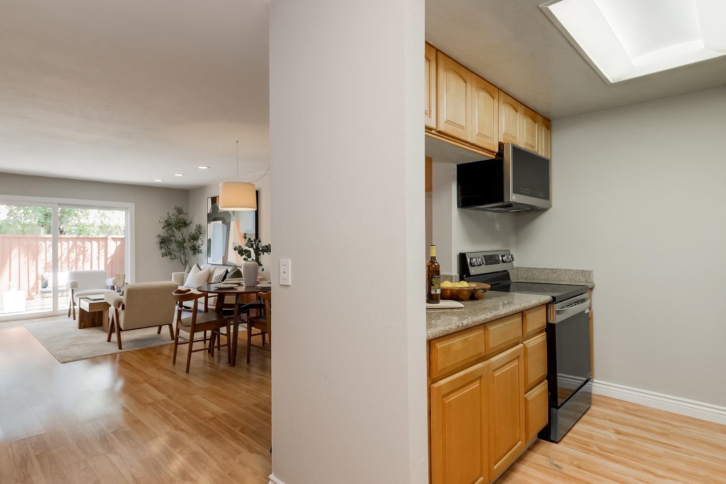1101 Reed Avenue, Unit B Sunnyvale, CA 94086 - Photo 2 of 19 a kitchen with a stove a sink and a refrigerator