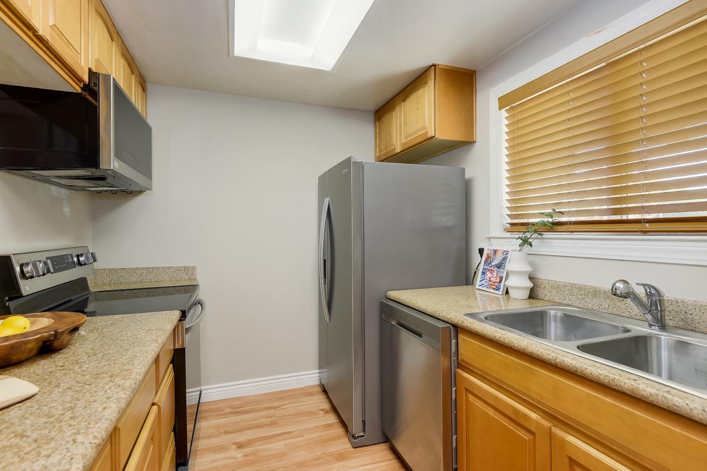 1101 Reed Avenue, Unit B Sunnyvale, CA 94086 - Photo 3 of 19 a kitchen that has a sink and a stove top oven