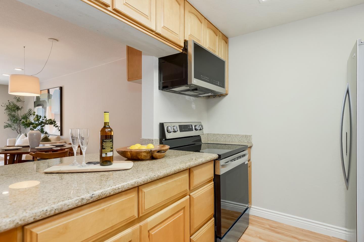 1101 Reed Avenue, Unit B Sunnyvale, CA 94086 - Photo 4 of 19 a kitchen with stainless steel appliances granite countertop a sink a stove and a microwave