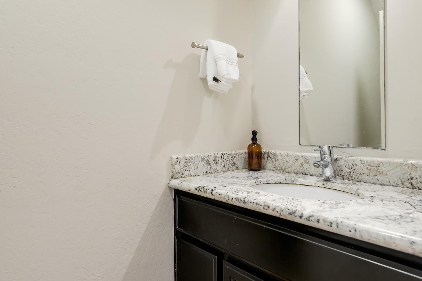 1101 Reed Avenue, Unit B Sunnyvale, CA 94086 - Photo 9 of 19 a bathroom with a granite countertop sink and a mirror