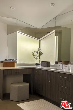 a view of a workspace with furniture and a floor to ceiling window
