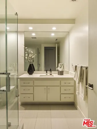 a spacious bedroom with a bed and a flat screen tv