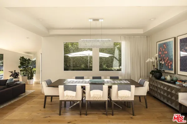 a dining room with furniture a rug and wooden floor