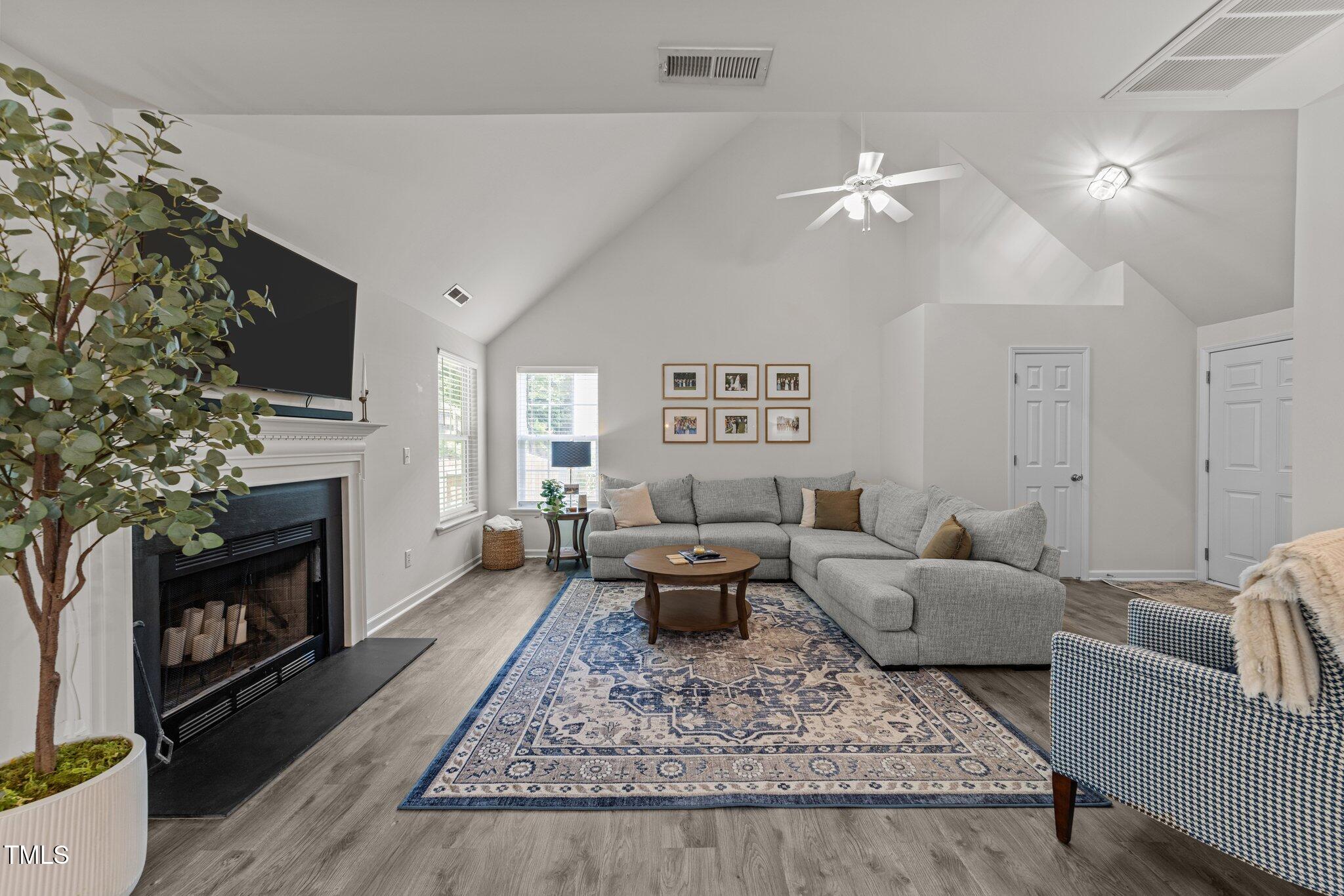 124 River Pearl Street Raleigh, NC 27603 - Photo 3 of 24 a living room with furniture and a fireplace
