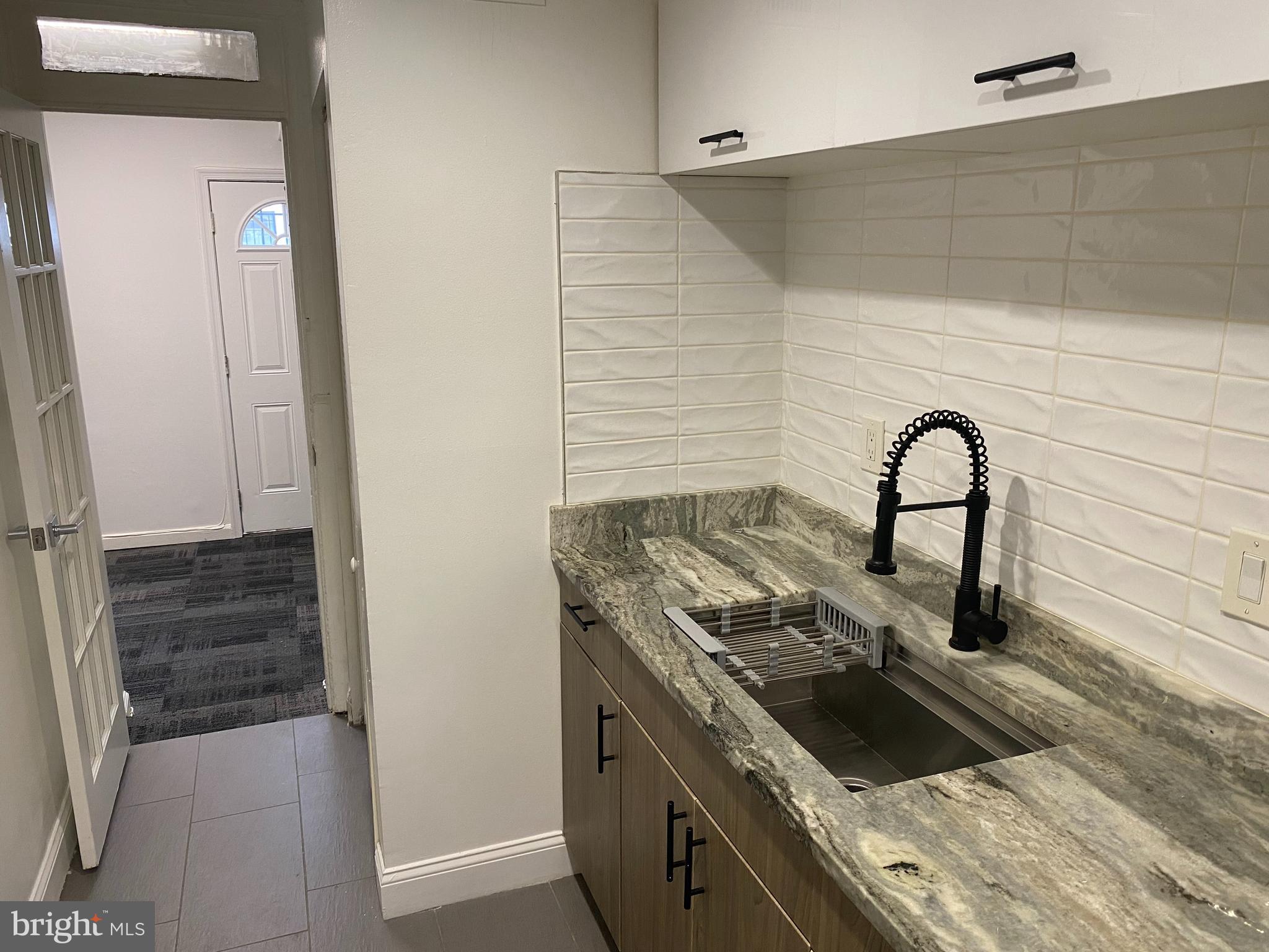 1122 Penn Street Northeast, Unit 1 Washington, DC 20002 - Photo 12 of 31 a kitchen with a stove and a sink