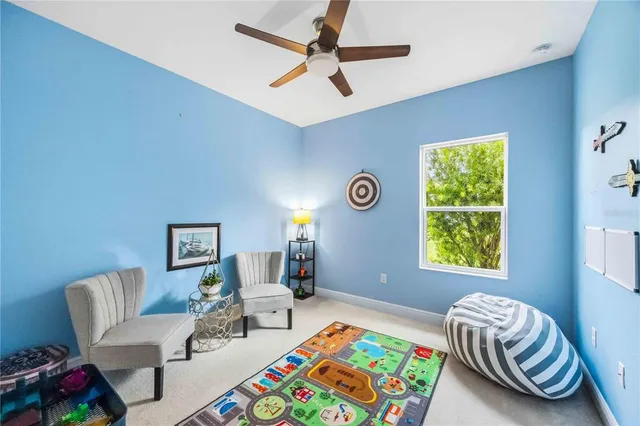 a view of a house with a yard and large tree