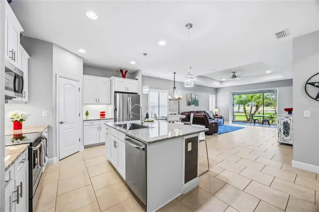 a kitchen with stainless steel appliances granite countertop a sink and cabinets
