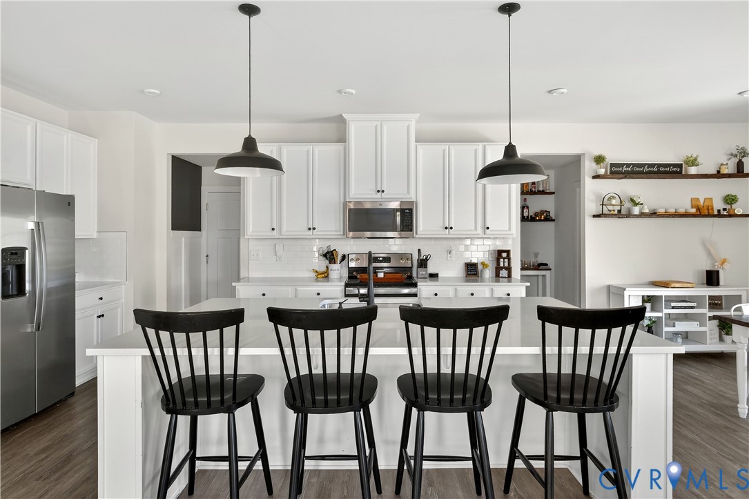 1618 Almer Lane Chester, VA 23836 - Photo 17 of 59 a view of a dining room and livingroom with furniture wooden floor kitchen chandelier