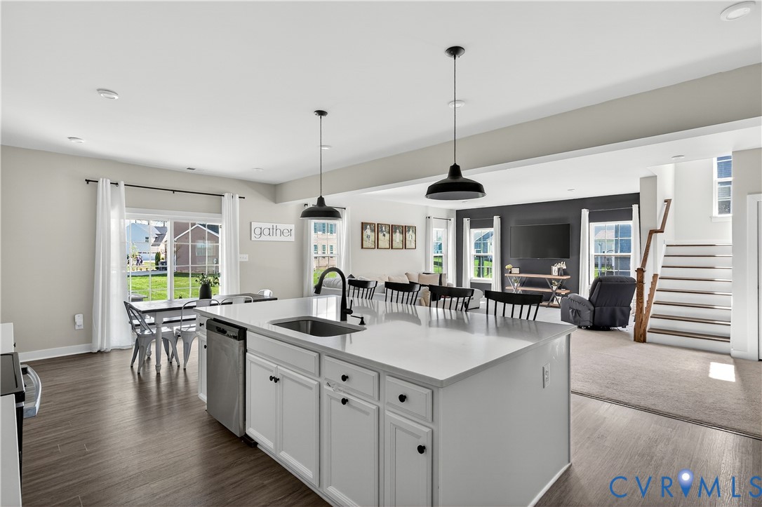 1618 Almer Lane Chester, VA 23836 - Photo 23 of 59 a kitchen with stainless steel appliances granite countertop a sink a stove top oven a dining table with wooden floor