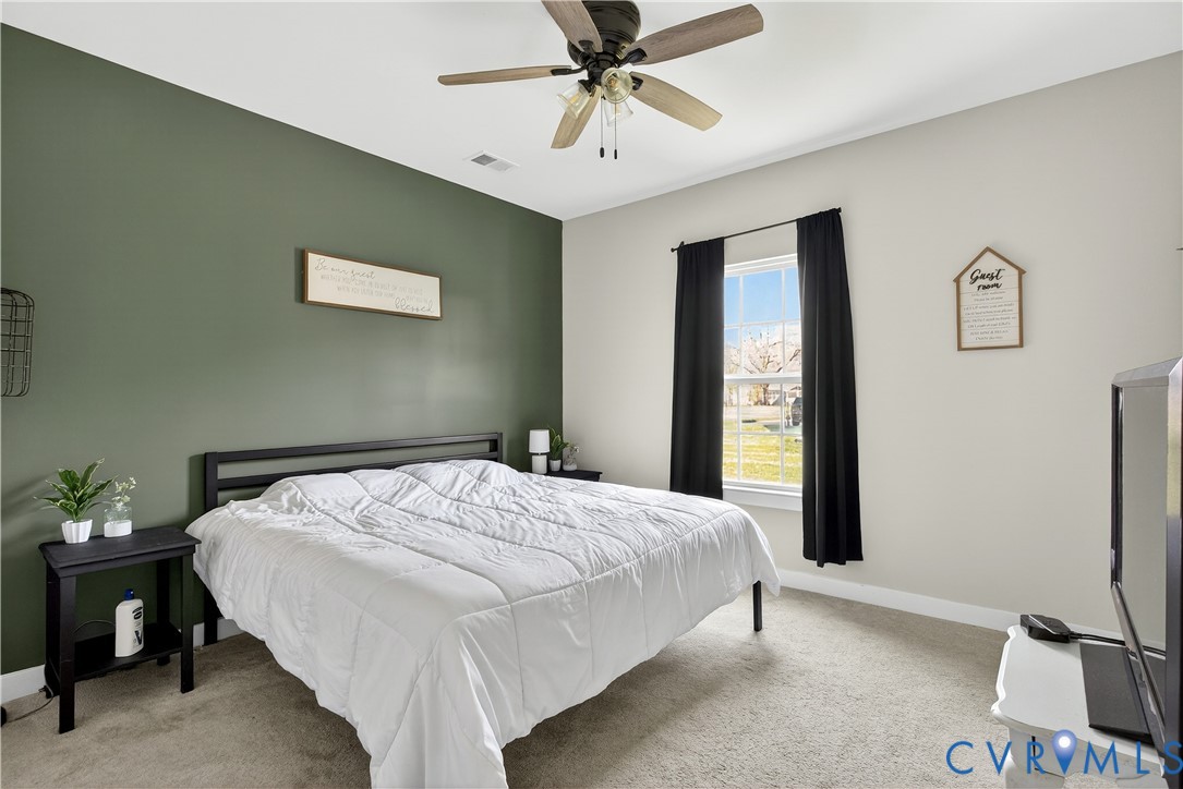 1618 Almer Lane Chester, VA 23836 - Photo 26 of 59 a bedroom with a bed and a chandelier