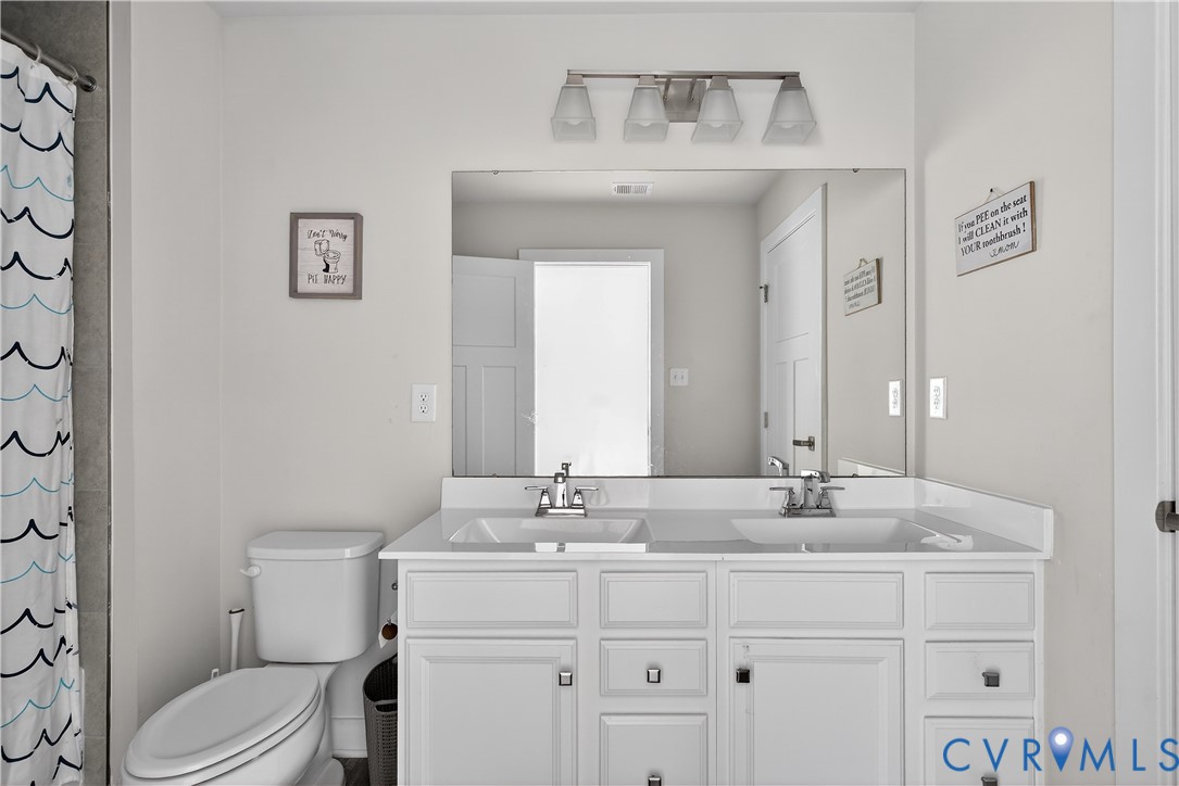 1618 Almer Lane Chester, VA 23836 - Photo 33 of 59 a bathroom with a toilet sink and mirror