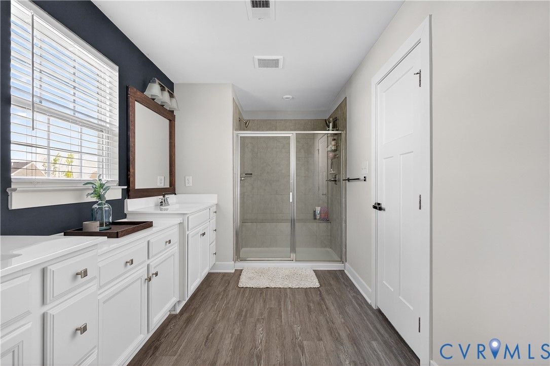 1618 Almer Lane Chester, VA 23836 - Photo 45 of 59 a bathroom with a double vanity sink a mirror and a shower