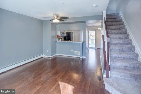 a view of a hallway view with wooden floor and staircase