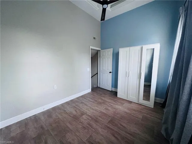 an empty room with wooden floor and a window