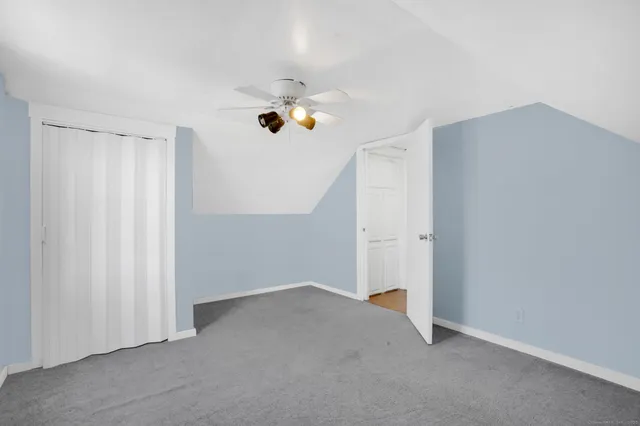 an empty room with closet and windows