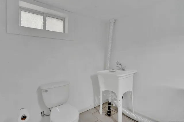 a bathroom with a sink a toilet and a mirror