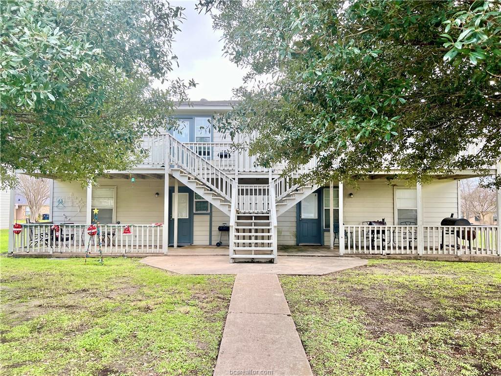 711 Vassar Court, Unit B College Station, TX 77840 - Photo 1 of 23 a front view of a house with a garden and plants