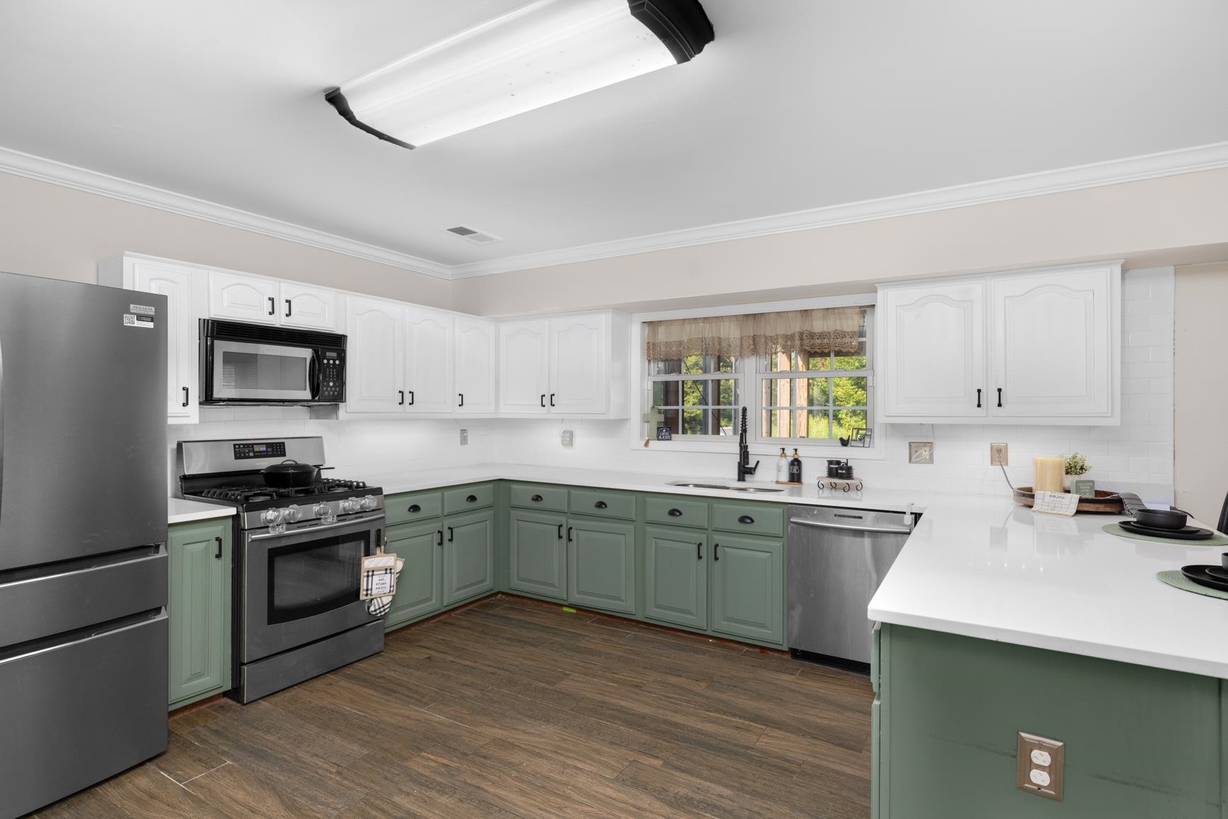 6525 North Watkins Road Millington, TN 38053 - Photo 12 of 35 a kitchen with a sink cabinets and stainless steel appliances