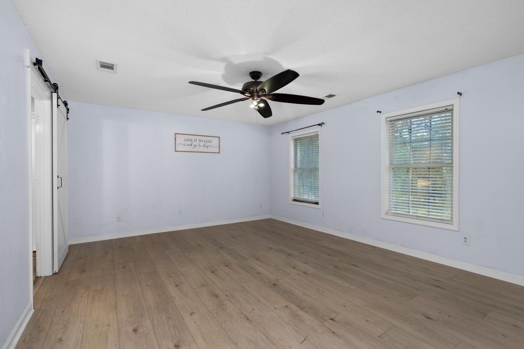 6525 North Watkins Road Millington, TN 38053 - Photo 17 of 35 a view of an empty room with a window and wooden floor