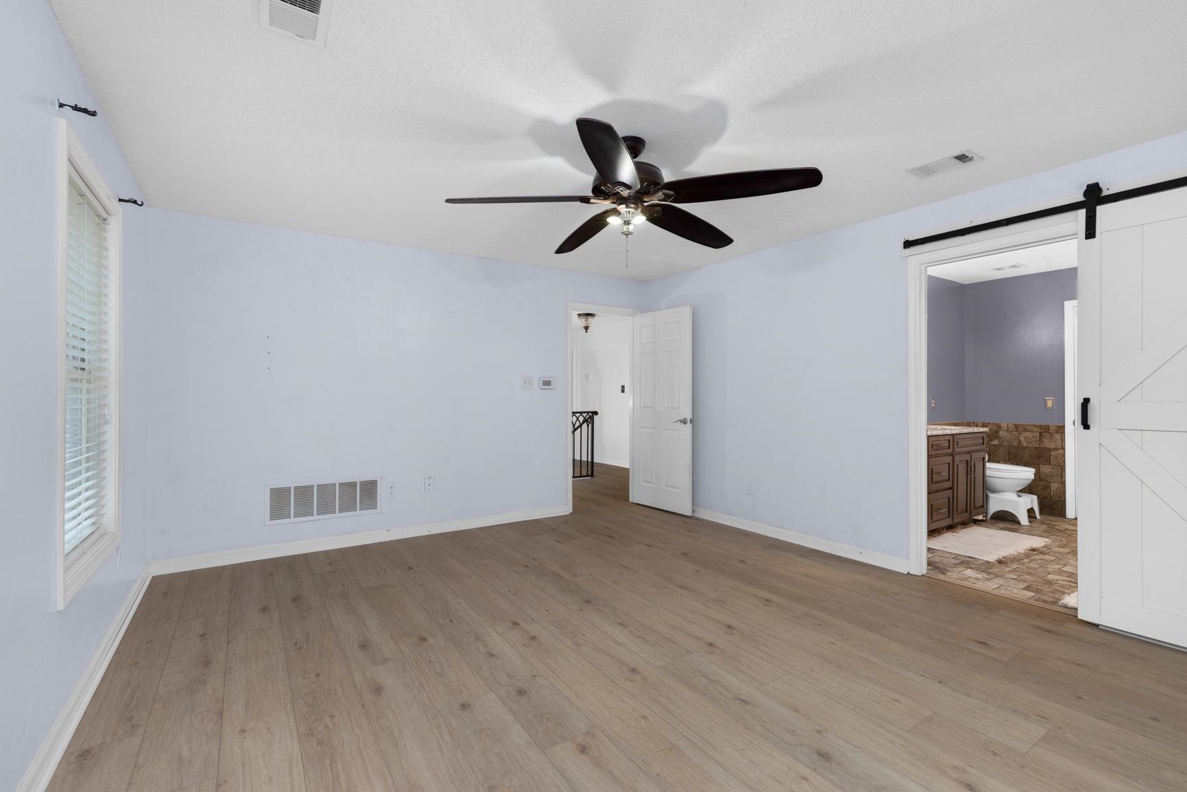 6525 North Watkins Road Millington, TN 38053 - Photo 18 of 35 a view of a livingroom with a ceiling fan and wooden floor
