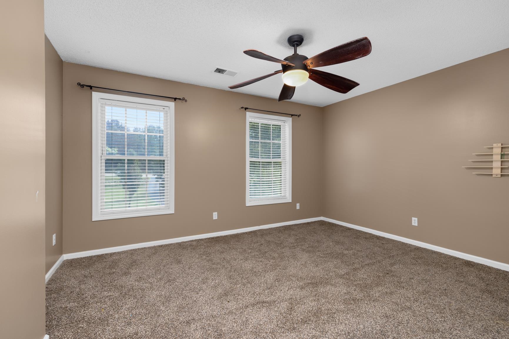 6525 North Watkins Road Millington, TN 38053 - Photo 23 of 35 a view of an empty room with a window and a ceiling fan