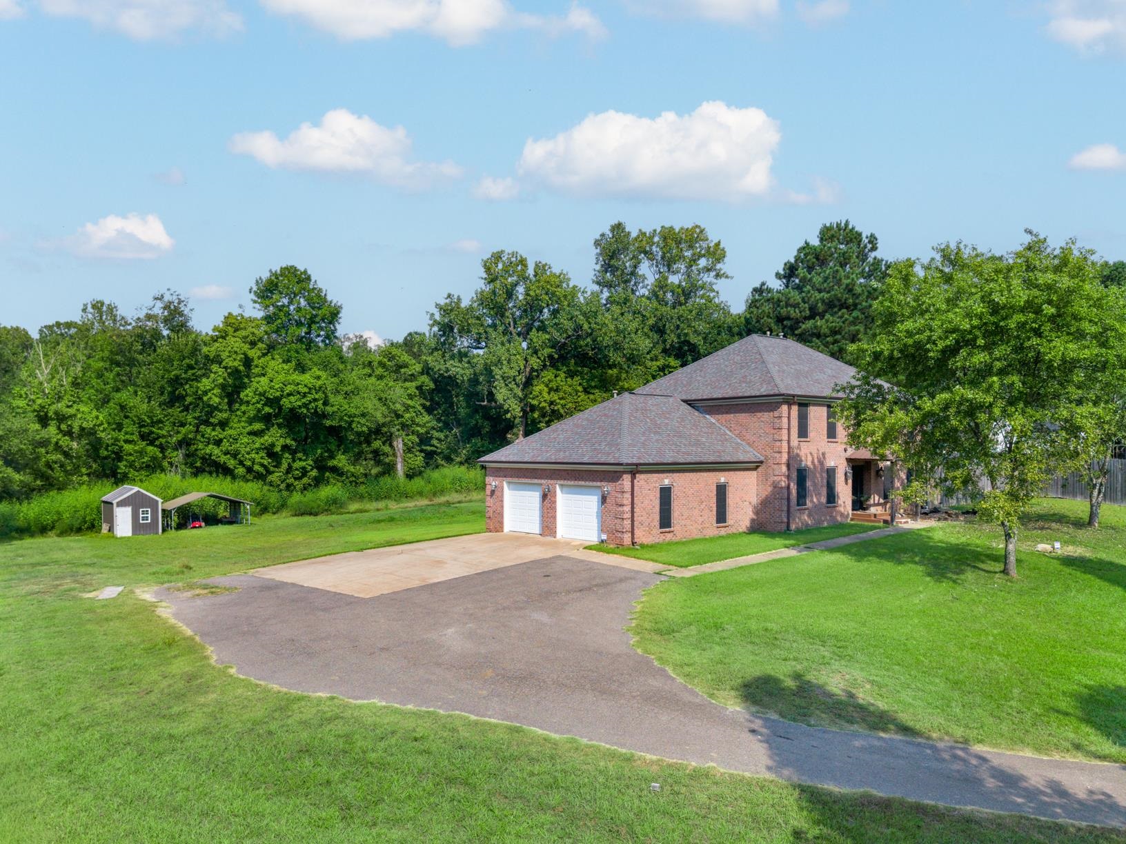 6525 North Watkins Road Millington, TN 38053 - Photo 31 of 35 a view of a house with a big yard and a large tree