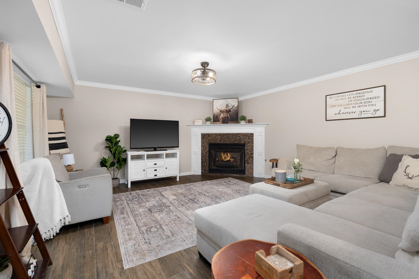 6525 North Watkins Road Millington, TN 38053 - Photo 5 of 35 a living room with furniture a flat screen tv and a fireplace