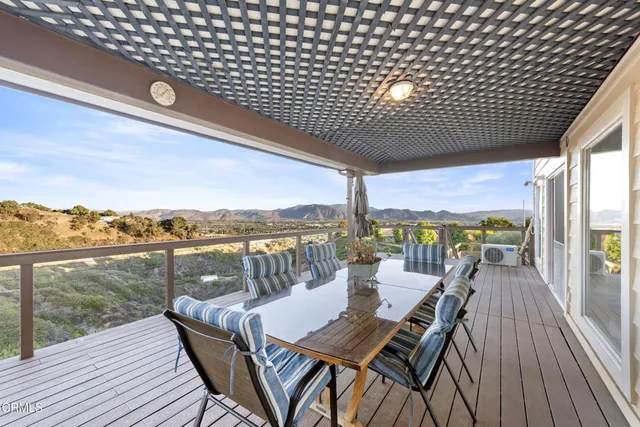 a view of a balcony with lake view and wooden floor