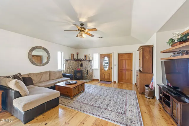 a living room with furniture a flat screen tv and a rug