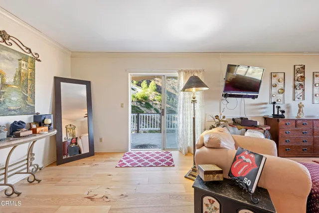 a bedroom with furniture and a flat screen tv