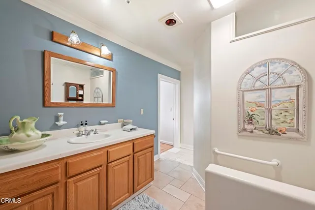 a bathroom with a sink a large mirror and a bathtub